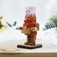 Christmas decoration nutcracker on table from resin in two variants - Penguin and pastry maker